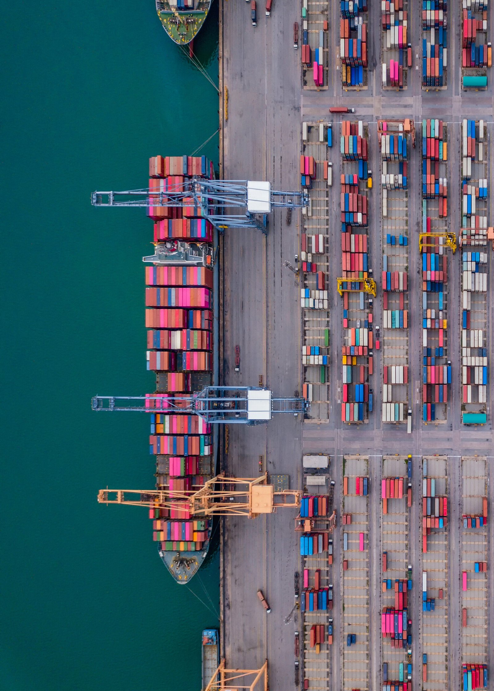 Aerial top view of container cargo ship in the export and import business and logistics international goods in urban city. Shipping to the harbor by crane in Laem Chabang, Chon Buri, Thailand